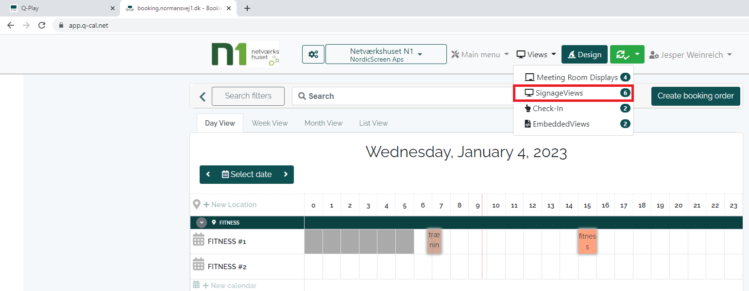 Q-Cal booking interface on January 4, 2023, showing the 'SignageViews' tab selected with notifications for meeting room displays and check-ins.